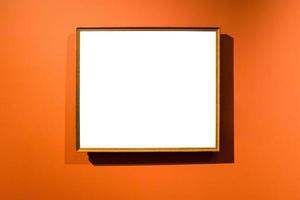 narrow wooden picture frame on orange wall photo