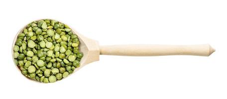 top view of wood spoon with green split peas photo