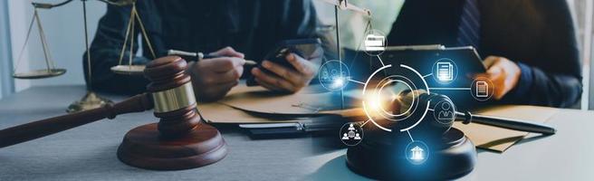 Justice and law concept. Gavel on sounding block in hand's Male judge at a courtroom, working with document law books, report the case on table in modern office. photo