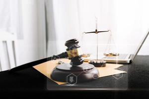 Justice and law concept.Male judge in a courtroom with the gavel, working with, computer and docking keyboard, eyeglasses, on table in morning light photo