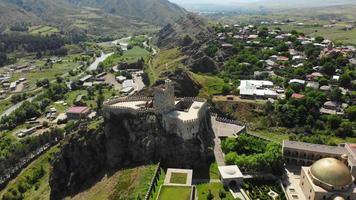 Aerial tilt down reveal view flag wave on Akhaltsikhe fortress on Rabati in Georgia in summer day video