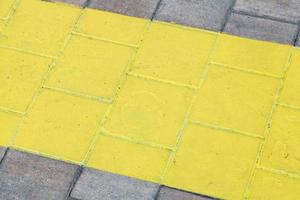 wide painted yellow line on pavement photo