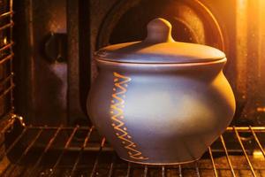 closed ceramic pot in electric oven photo