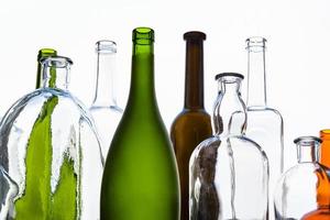 various empty bottles and view of sky in window photo