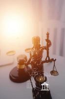 Justice and law concept.Male judge in a courtroom with the gavel, working with, computer and docking keyboard, eyeglasses, on table in morning light photo