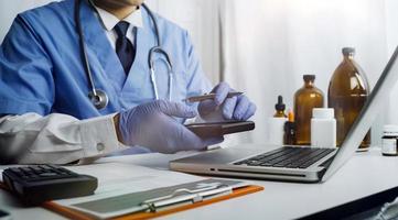 Medicine doctor hand working on a patients x-ray scans digital healthcare and connection with modern virtual screen interface icons, Medical technology and network concept. photo