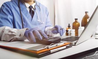 Medicine doctor hand working on a patients x-ray scans digital healthcare and connection with modern virtual screen interface icons, Medical technology and network concept. photo