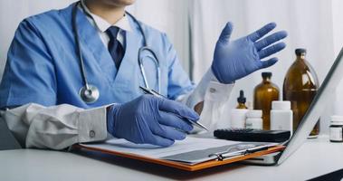 Medicine doctor hand working on a patients x-ray scans digital healthcare and connection with modern virtual screen interface icons, Medical technology and network concept. photo
