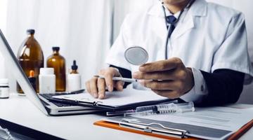 Medicine doctor hand working on a patients x-ray scans digital healthcare and connection with modern virtual screen interface icons, Medical technology and network concept. photo