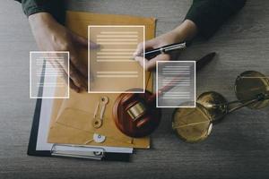 Male lawyer working with contract papers and wooden gavel on tabel in courtroom. justice and law ,attorney, court judge, concept. photo