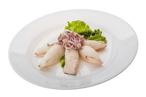 Boiled squid on the plate and white background photo
