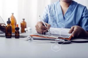 Medicine doctor hand working on a patients x-ray scans digital healthcare and connection with modern virtual screen interface icons, Medical technology and network concept. photo