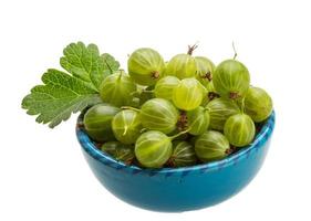 Gooseberries in a bowl on white background photo