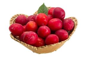 Damson plum in a basket on white background photo