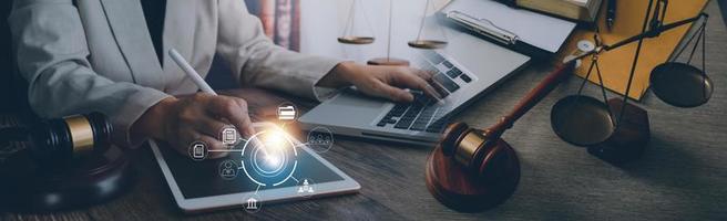 Justice and law concept. Gavel on sounding block in hand's Male judge at a courtroom, working with document law books, report the case on table in modern office. photo