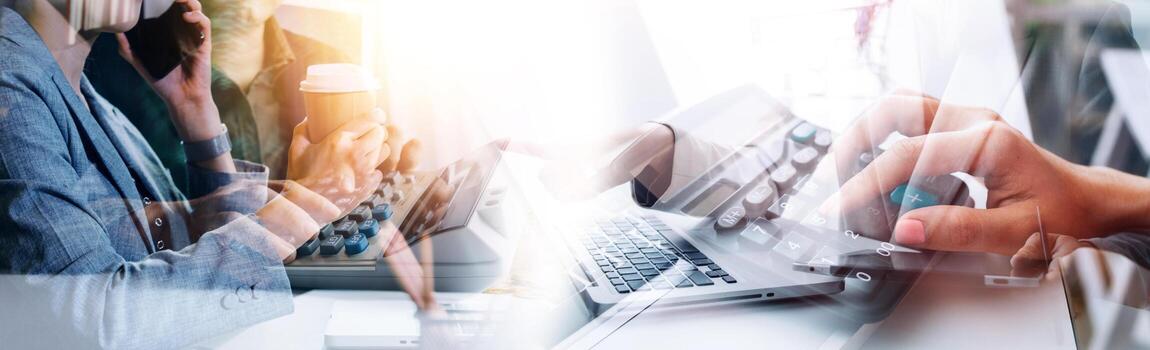 Business team finance or bookkeeper working with a calculator to calculate business data summary report, accountancy document and laptop computer at the office, business meeting concept photo