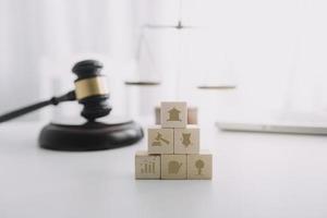 Justice and law concept.Male judge in a courtroom with the gavel, working with, computer and docking keyboard, eyeglasses, on table in morning light photo