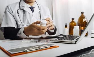 Medicine doctor hand working on a patients x-ray scans digital healthcare and connection with modern virtual screen interface icons, Medical technology and network concept. photo