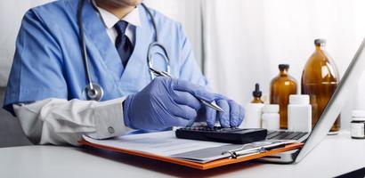 Medicine doctor hand working on a patients x-ray scans digital healthcare and connection with modern virtual screen interface icons, Medical technology and network concept. photo