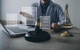 Male lawyer working with contract papers and wooden gavel on tabel in courtroom. justice and law ,attorney, court judge, concept. photo