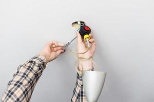 man repairing defected ceiling lamp photo