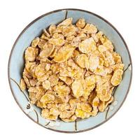 sugar coated cornflakes in round bowl isolated photo