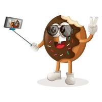 Cute donut mascot takes a selfie with smartphone vector