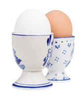 pair of white and brown boiled eggs in cups photo