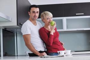 young couple have fun in modern kitchen photo