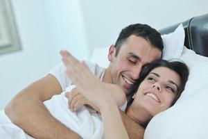 young couple have good time in their bedroom photo