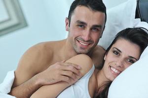 young couple have good time in their bedroom photo