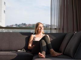 Woman Using Tablet On Couch At Home photo