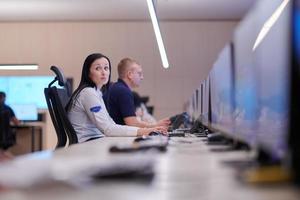 Female operator working in a security data system control room photo