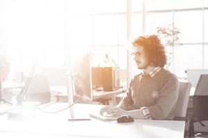 Young businessman using computer at work photo