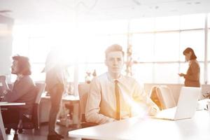 Young businessman using computer at work photo