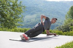 man doing morning yoga exercises photo