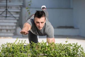 man doing morning yoga exercises photo