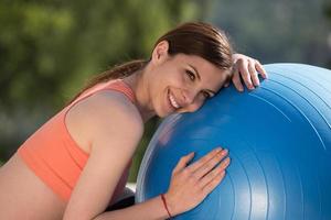 woman doing exercise with pilates ball photo