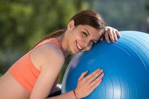 woman doing exercise with pilates ball photo