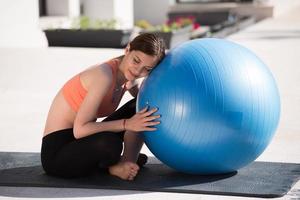 woman doing exercise with pilates ball photo