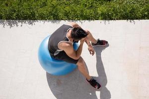 Man on exercise ball photo