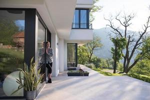 woman in front of her luxury home villa photo