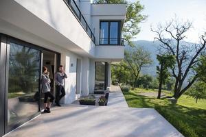 couple enjoying on the door of their luxury home villa photo