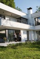 couple enjoying on the door of their luxury home villa photo