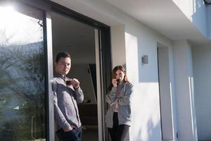 couple enjoying on the door of their luxury home villa photo