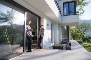 couple enjoying on the door of their luxury home villa photo