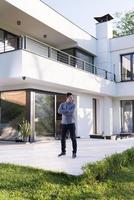 man in front of his luxury home villa photo