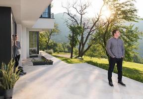 man in front of his luxury home villa photo