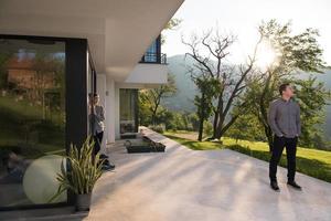 man in front of his luxury home villa photo