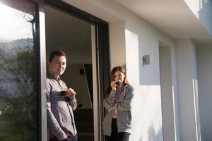 couple enjoying on the door of their luxury home villa photo